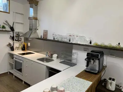 a kitchen with a sink and a counter with a microwave at Пътепис in Bratsigovo