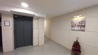 a christmas tree in a hallway with a door at ATM apart Lagera in Sofia