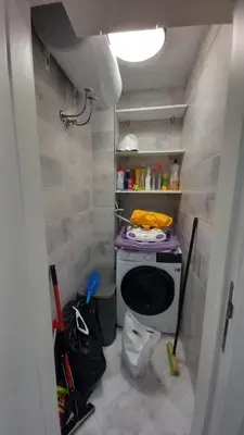 a small bathroom with a stove and a toilet at ATM apart Lagera in Sofia