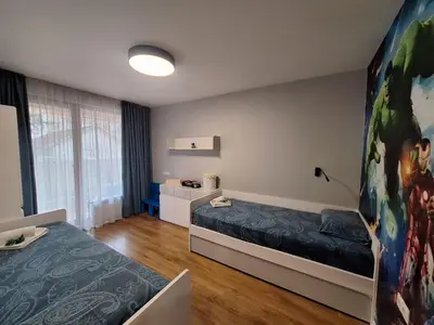 a bedroom with two beds and a large window at ATM apart Lagera in Sofia