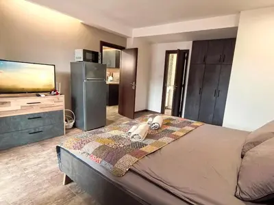 a bedroom with a dog laying on a bed at Cozy 1BR Mountain View Suite for 4 Guests in Bansko
