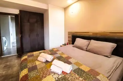 a bedroom with a bed with two towels on it at Cozy 1BR Mountain View Suite for 4 Guests in Bansko