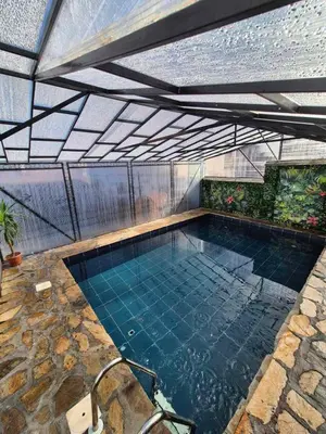 an indoor swimming pool with a glass roof at Old House - Стара Къща in Koprivshtitsa