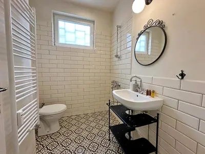 a white bathroom with a sink and a toilet at Romantic 1BDR apt near Eagle bridge - Fast Wi-Fi in Sofia