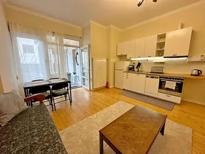 a living room with a table and a kitchen at Romantic 1BDR apt near Eagle bridge - Fast Wi-Fi in Sofia