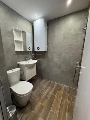 a bathroom with a toilet and a sink at MedHill Stay - Medical University Area in Plovdiv