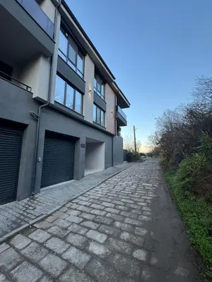 a cobblestone street in front of a building at MedHill Stay - Medical University Area in Plovdiv