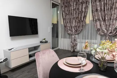 a living room with a dining table and a television at Wings Apartment 1 Bedroom Luxury-free parking in Sofia