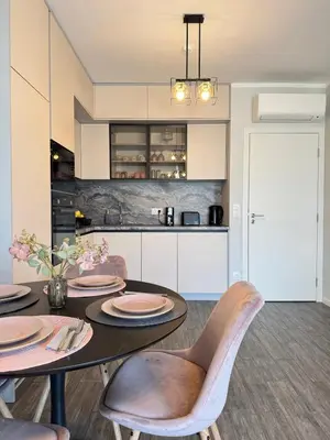 a kitchen and dining room with a table and chairs at Wings Apartment 1 Bedroom Luxury-free parking in Sofia