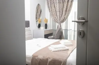 a bedroom with a bed with two towels on it at Wings Apartment 1 Bedroom Luxury-free parking in Sofia
