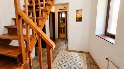 a wooden staircase in a room with a hallway at Penthouse Duplex Large 2 Bedroom MP1 in Bansko