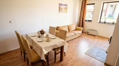 a living room with a table and a couch at Penthouse Duplex Large 2 Bedroom MP1 in Bansko