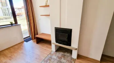 a living room with a fireplace in the corner at Penthouse Duplex Large 2 Bedroom MP1 in Bansko