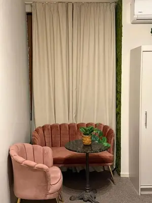 a couch and a table in front of a window at Top Center Apartment Sofia in Sofia