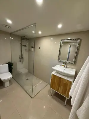 a bathroom with a sink and a toilet and a mirror at Top Center Apartment Sofia in Sofia