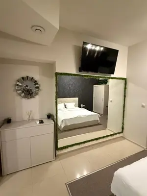 a bedroom with a large mirror on the wall at Top Center Apartment Sofia in Sofia