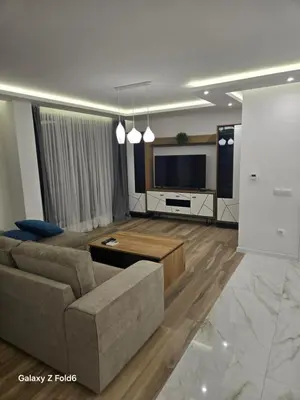 a living room with a couch and a flat screen tv at Diljanka 4 in Pernik