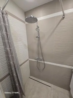 a shower with a shower head in a bathroom at Diljanka 4 in Pernik