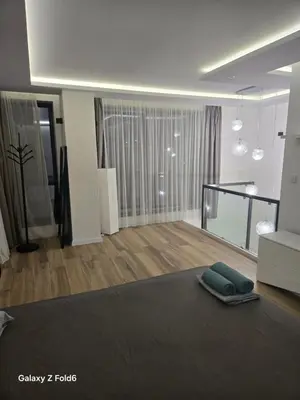 a living room with a couch and a living room with a couch at Diljanka 4 in Pernik