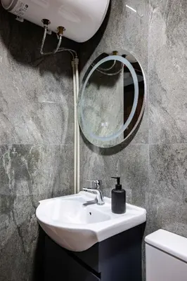 a bathroom with a sink and a mirror at Stylish 1 Bedroom Apartment - Quiet & Comfortable in Sofia