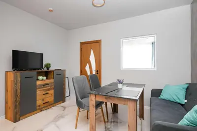 a living room with a table and a couch at Stylish 1 Bedroom Apartment - Quiet & Comfortable in Sofia