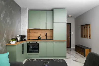 a kitchen with green cabinets and a sink at Stylish 1 Bedroom Apartment - Quiet & Comfortable in Sofia