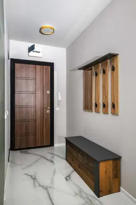 a room with a wooden door and a marble floor at Stylish 1 Bedroom Apartment - Quiet & Comfortable in Sofia