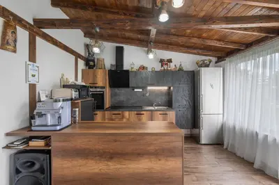 a kitchen with a wooden counter and a refrigerator at Къща за гости Мартинели