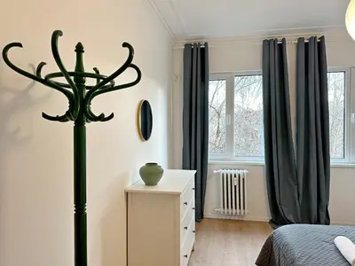 a bedroom with a bed and a dresser and window at Spacious bright cozy 2BDR fast Wi-Fi next to Park in Sofia