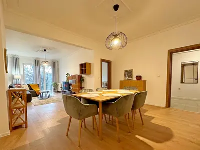 a dining room and living room with a table and chairs at Spacious bright cozy 2BDR fast Wi-Fi next to Park in Sofia