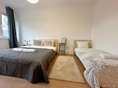a bedroom with two beds and a window at Spacious bright cozy 2BDR fast Wi-Fi next to Park in Sofia