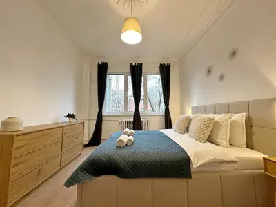 a bedroom with a bed with two teddy bears on it at Spacious bright cozy 2BDR fast Wi-Fi next to Park in Sofia
