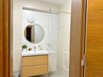 a bathroom with a sink and a mirror at Spacious bright cozy 2BDR fast Wi-Fi next to Park in Sofia