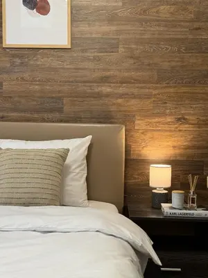 a bedroom with a bed and a wooden wall at Top Centre Plovdiv Apartment for 4 Guests & Parking in Plovdiv