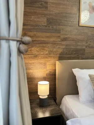 a room with a bed and a lamp on a wall at Top Centre Plovdiv Apartment for 4 Guests & Parking in Plovdiv