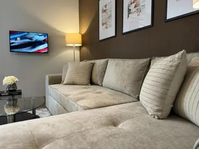 a living room with a couch and a tv at Top Centre Plovdiv Apartment for 4 Guests & Parking in Plovdiv
