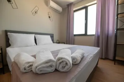 a bedroom with white towels on a bed at Apartments by the river 2 in Plovdiv