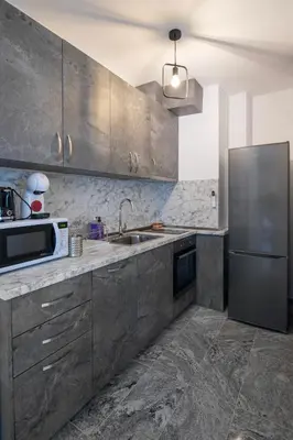 a kitchen with a stainless steel refrigerator and a microwave at Apartments by the river 2 in Plovdiv