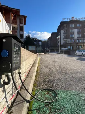 a parking meter sitting on the side of a street at Smart Stay - Refurbished Studio with Balcony and Parking in Bansko