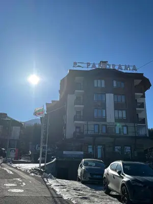 two cars parked in front of a building at Smart Stay - Refurbished Studio with Balcony and Parking in Bansko