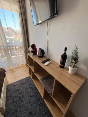a room with a wooden shelf with a tv on the wall at Smart Stay - Refurbished Studio with Balcony and Parking in Bansko