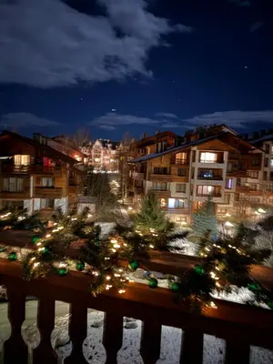 a city at night with christmas trees and buildings at Smart Stay - Refurbished Studio with Balcony and Parking in Bansko