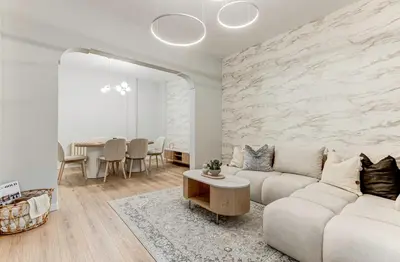 a living room with a couch and a table at Prime Central Sofia Living Modern 2BR Apt in Sofia