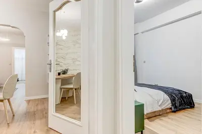 a bedroom with a mirror and a bed and a table at Prime Central Sofia Living Modern 2BR Apt in Sofia