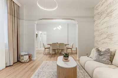 a living room with a couch and a table at Prime Central Sofia Living Modern 2BR Apt in Sofia