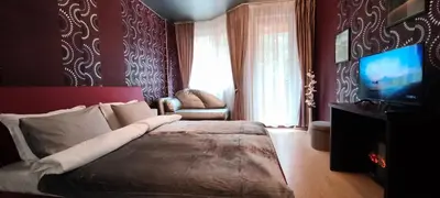 a bedroom with a large bed and a television at Iceberg Studio 15 in Borovets