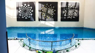 a swimming pool with four pictures on the wall at Iceberg Studio 15 in Borovets