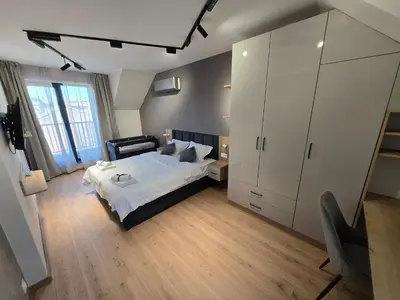 a bedroom with a bed and a large white cabinet at Plovdiv Hills Apartments with FREE Parking in Plovdiv