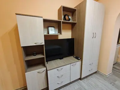 a room with a entertainment center with a flat screen tv at Apartment M 1 in Plovdiv