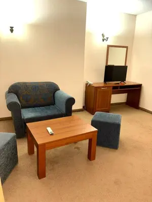 a living room with a couch and a table at Еmerald Apartment Complex in Bansko